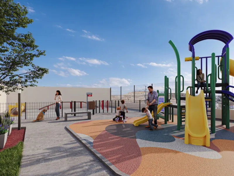 Área de juegos infantiles con resbaladillas y piso de caucho de colores