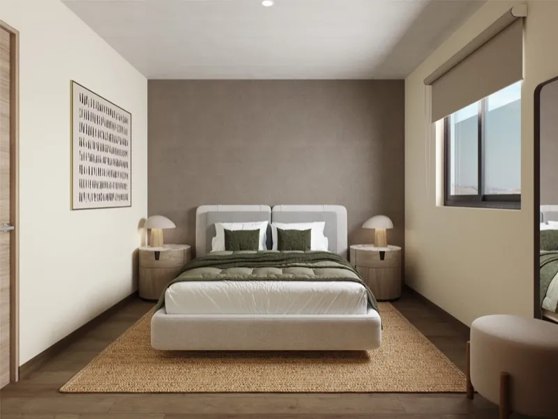 Recámara principal con cama king, buróes y muro en tono tierra