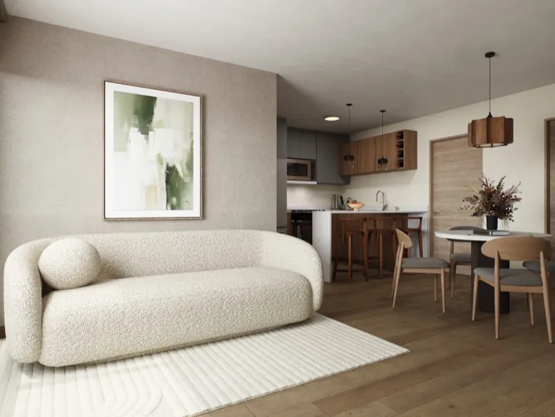 Sala del modelo CIMA con sofá bouclé, cocina integral al fondo y piso de madera